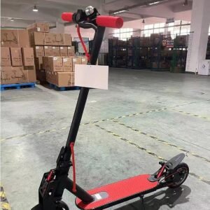 CITY 500W electric scooter with red deck, photographed in the factory warehouse