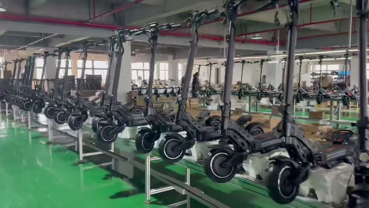 Electric scooters lined up along the assembly line at the factory