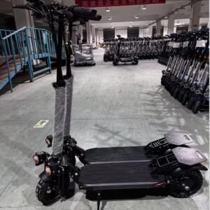 SPORT 1200W electric scooter on the factory floor beside finished units